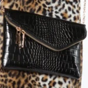 black purse with gold strap